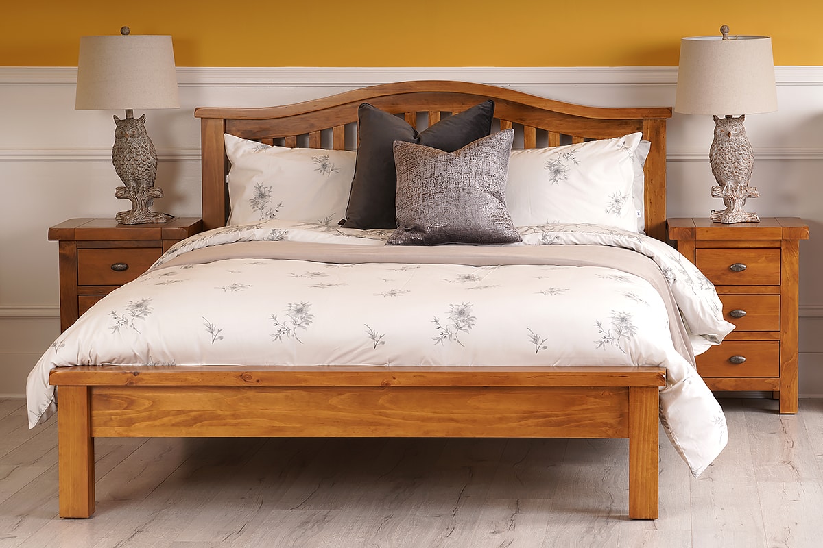 soft curve of the bed frame's headboard adds a welcome touch to the classic design